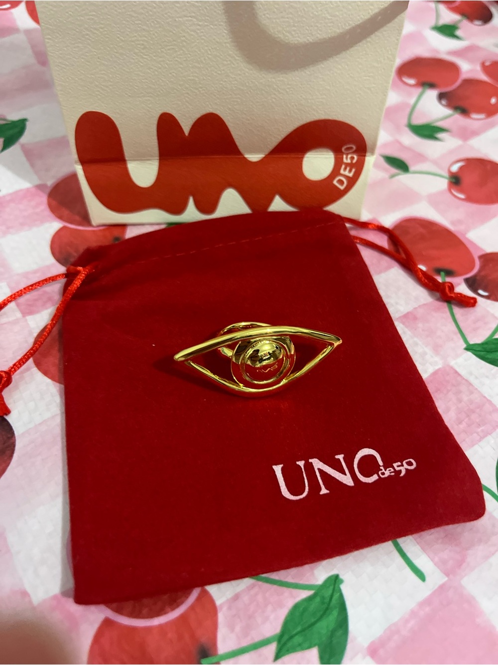 UNOde50 Gold Eye Ring on Red Pouch